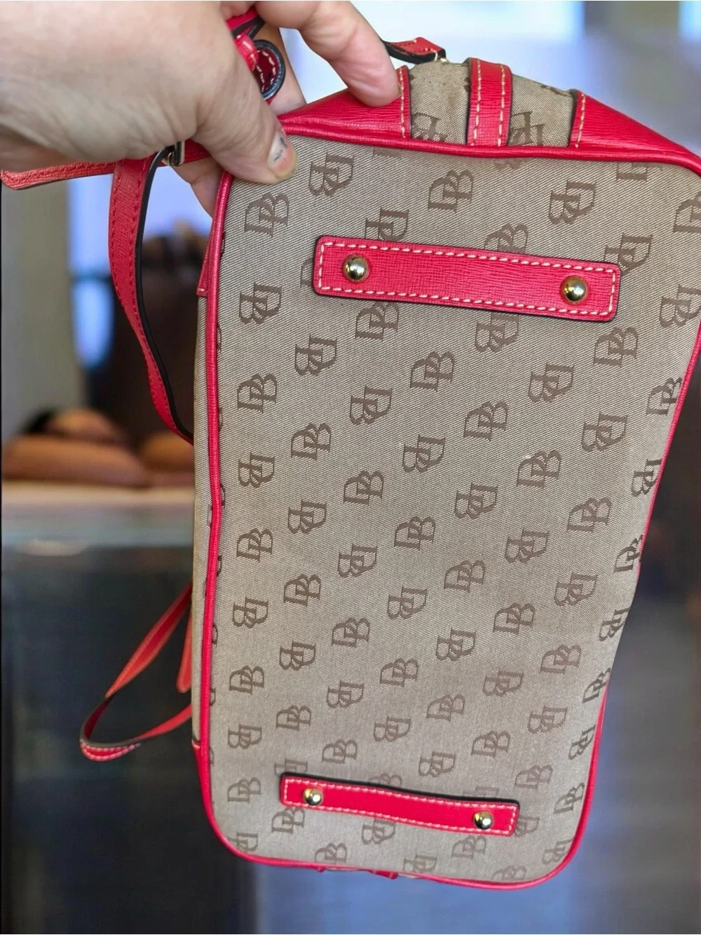Dooney & Bourke Signature monogram satchel features vibrant pink leather trim